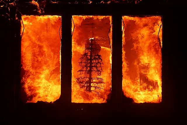 The Palisades Fire burns a Christmas tree inside a residence in the Pacific Palisades area