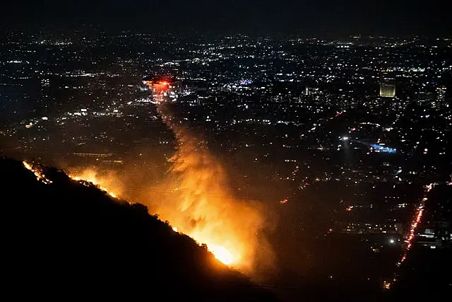 Water is dropped by helicopter on the burning Sunset Fire in the Hollywood Hills