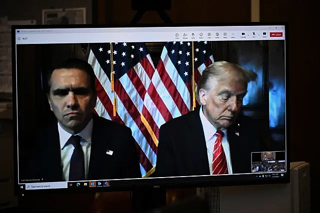 Lawyer Todd Blanche and Donald Trump on a TV screen