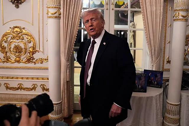 President-elect Donald Trump arrives to speak during a meeting with Republican governors at Mar-a-Lago in Palm Beach, Florida 