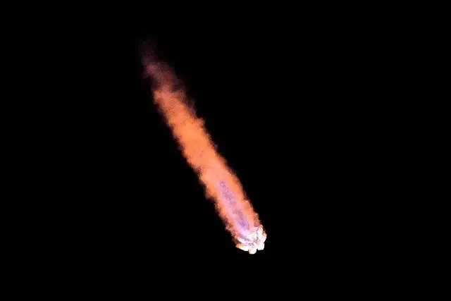 A red rocket tail in the night sky