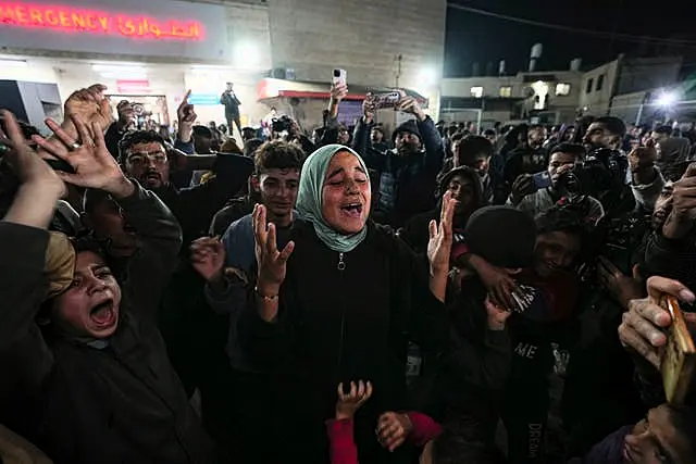 Palestinians celebrate the announcement of a ceasefire deal between Hamas and Israel in Deir al-Balah, central Gaza