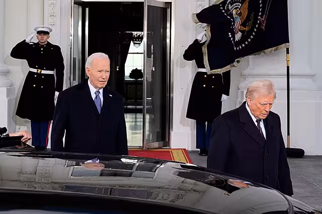 President Joe Biden and President-elect Donald Trump walk out to the presidential limousine, as they depart the White House in Washington en route to the Capitol
