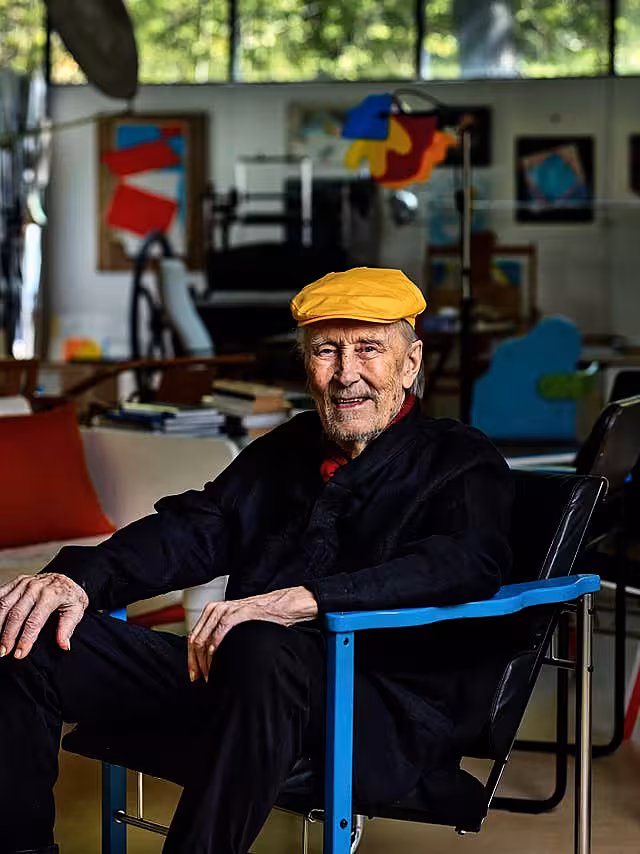 Yrjo Kukkapuro sitting in his famous Experiment chair in his studio outside Helsinki 