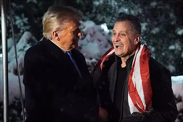President Donald Trump greets Marc Fogel on the South Lawn at the White House
