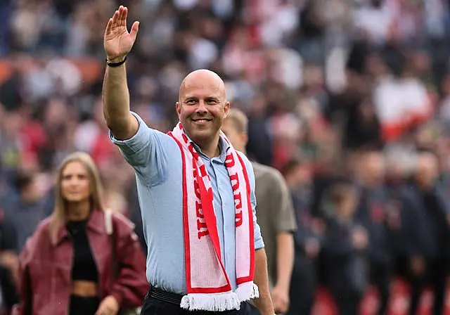 Arne Slot, with a Feyenoord scarf around his neck, waves to the crwod