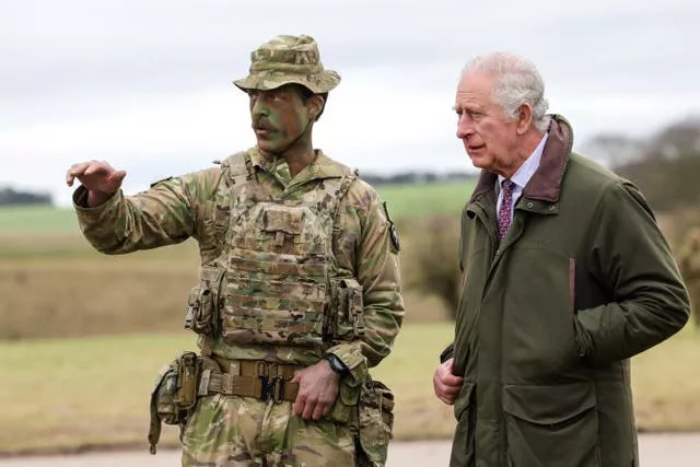 The King meets Major Tony Harris ahead of a trench attack and defence simulation during a visit to a training site for Ukrainian military recruits in Wiltshire 