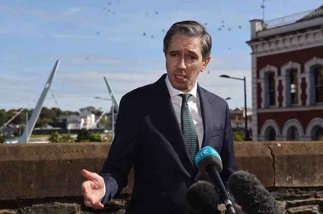 Simon Harris speaking to the media in Londonderry