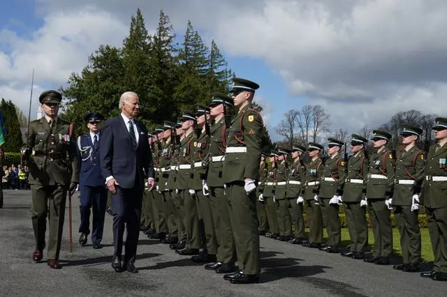US President Joe Biden inspects the guard of honour as he arrives for a meeting with Irish President Michael D Higgins, at Aras an Uachtarain in Phoenix Park, Dublin