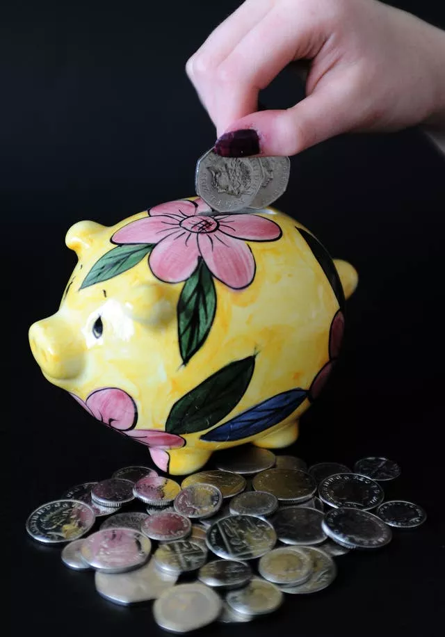 Money being put in a piggy bank