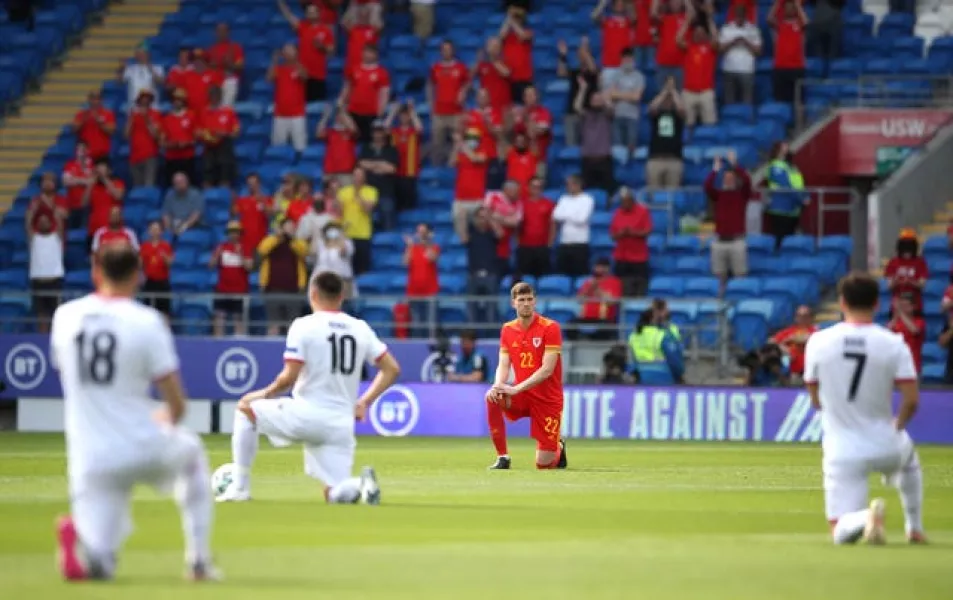 Wales and Albania players take the knee prior to kick-off