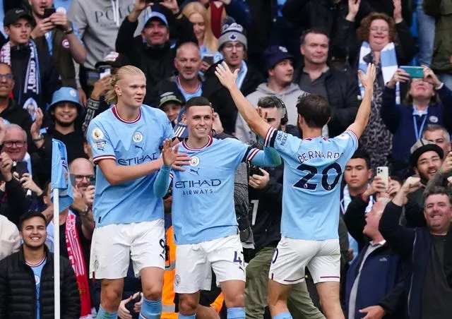 Erling Haaland, left, and Phil Foden celebrate the latter's hat-trick against Manchester United
