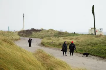 People walk on Bull Island in Dublin as Storm Dudley makes its way over Ireland