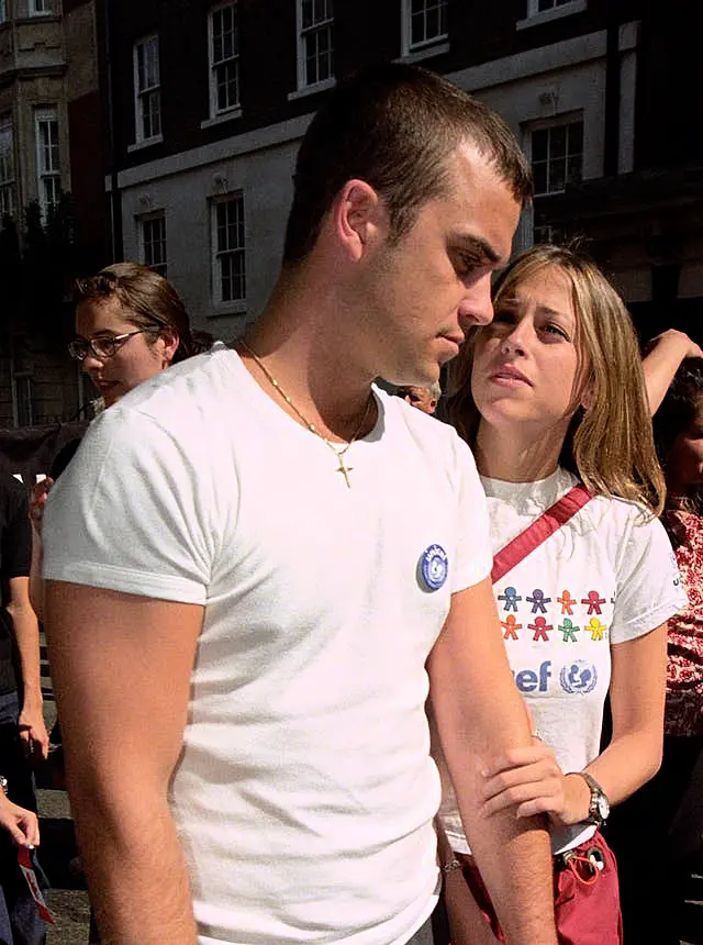 Singer Robbie Williams and girlfriend Nicole Appleton from All Saints march through London in August 1998 to urge the world's superpowers to back Princess Diana's campaign to ban landmines