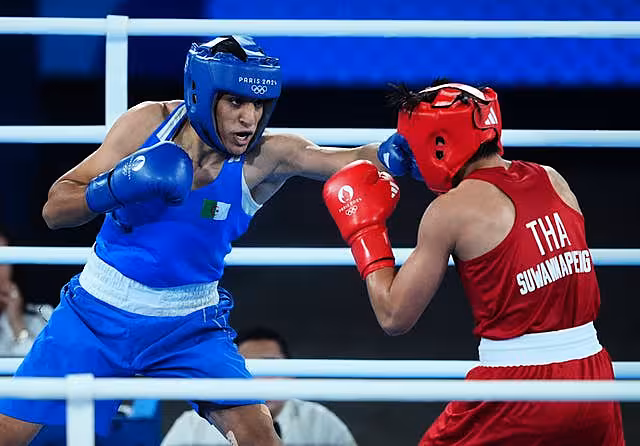 Imane Khelif, left, lands a jab on Thailand's Janjaem Suwannapheng during her Olympic semi-final