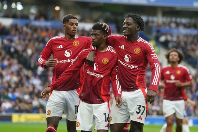 Marcus Rashford, Amad Diallo and Kobbie Mainoo celebrate a goal