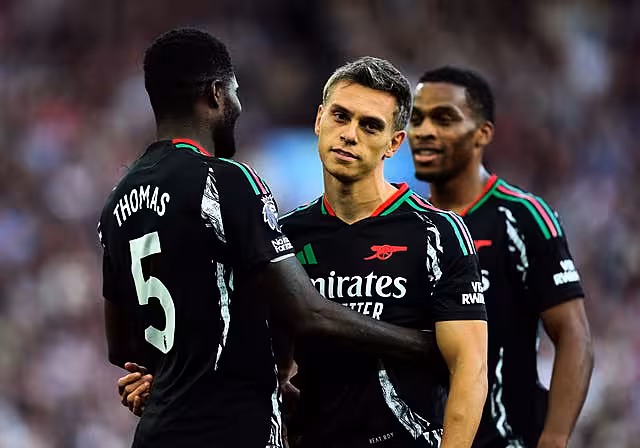 Thomas Partey, left, congratulates Leandro Trossard as the Arsenal winger barely celebrates his goal against Aston Villa