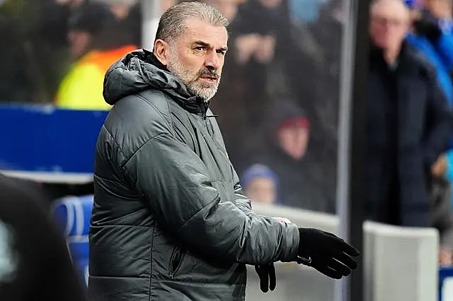 Ange Postecoglou stands in the dugout at Ibrox