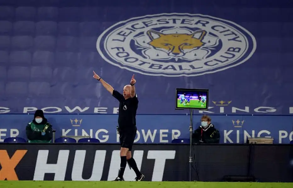 Referee Lee Mason overturns a Leicester penalty