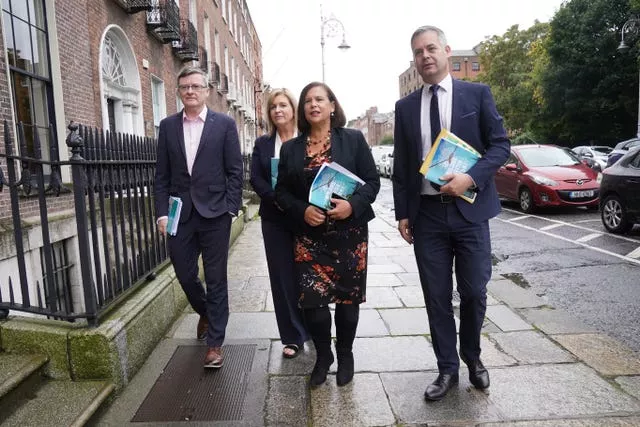 Two women and two men walking along a street