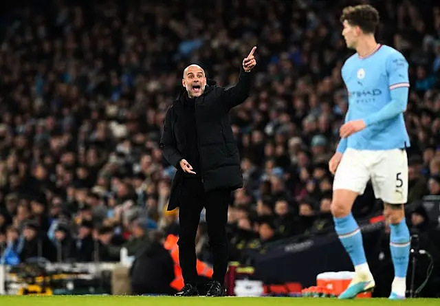 Pep Guardiola gestures to his players