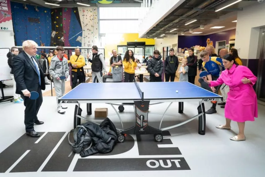 Prime Minister Boris Johnson plays table tennis with Home Secretary Priti Patel during a visit to the HideOut Youth Zone in Manchester