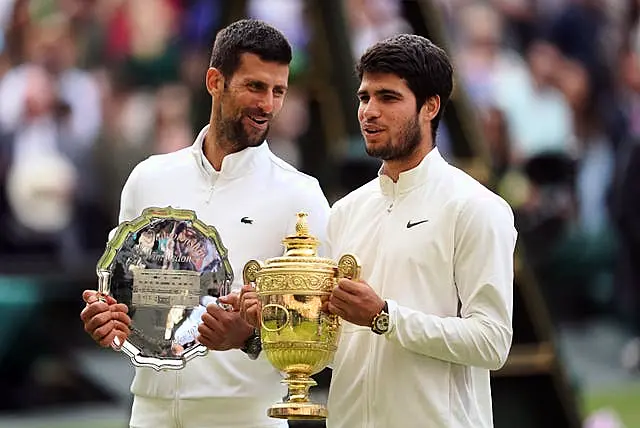 Carlos Alcaraz, right, with his Wimbledon trophy alongside runner-up Novak Djokovic 