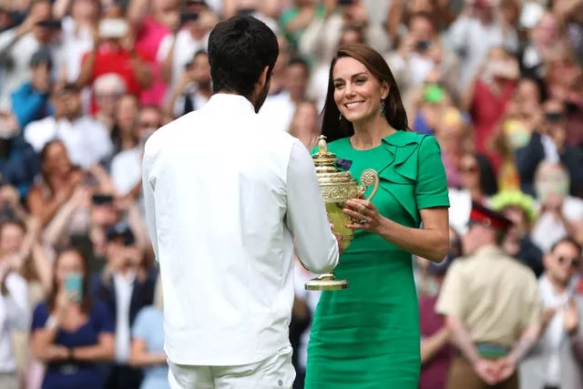 Carlos Alcaraz is presented with the Gentlemen’s Singles Trophy by the Princess of Wales, following his victory over Novak Djokovic at the 2023 Championships