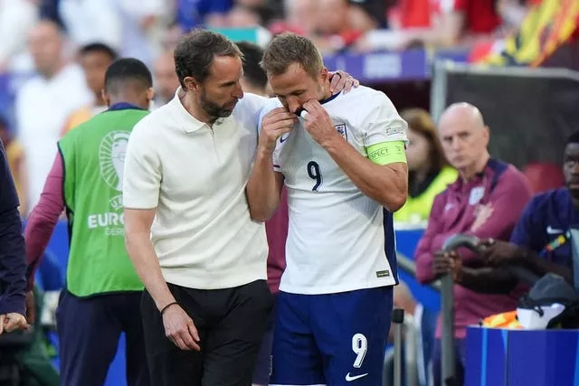 Gareth Southgate with his arm around Harry Kane after the captain took a tumble during England's match against Switzerland