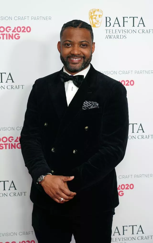 JB Gill in front of Bafta Television Craft Awards backdrop