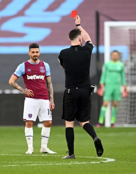 West Ham's Fabian Balbuena is controversially shown a red card by referee Chris Kavanagh after catching Ben Chilwell in his follow-through as he cleared the ball