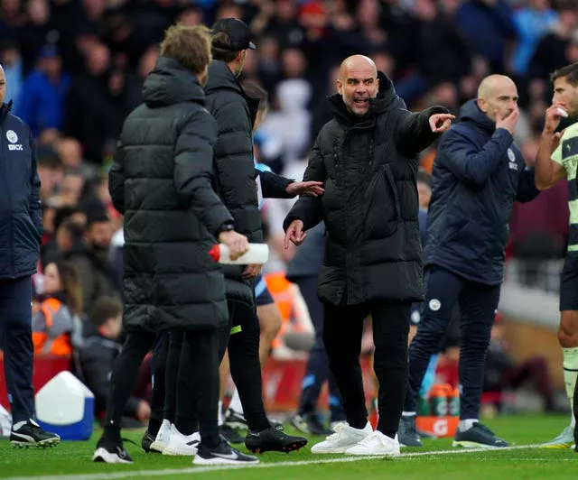 Manchester City boss Pep Guardiola and Liverpool manager Jurgen Klopp exchange views on the touchline