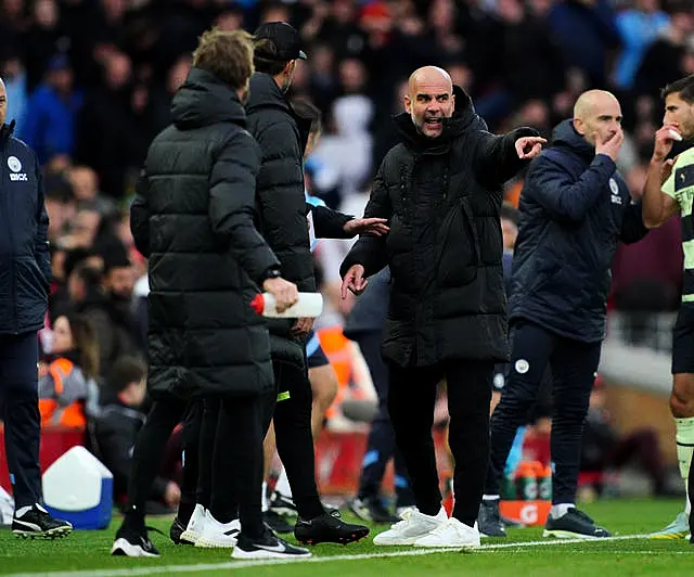 Manchester City boss Pep Guardiola and Liverpool manager Jurgen Klopp exchange views on the touchline