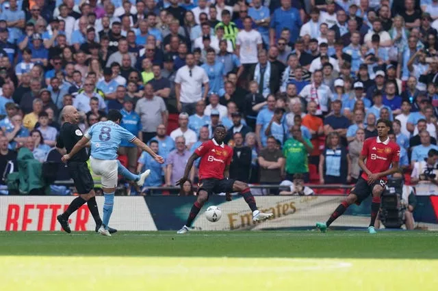 Ilkay Gundogan, second left, scores his and Manchester City’s second goal in the FA Cup final