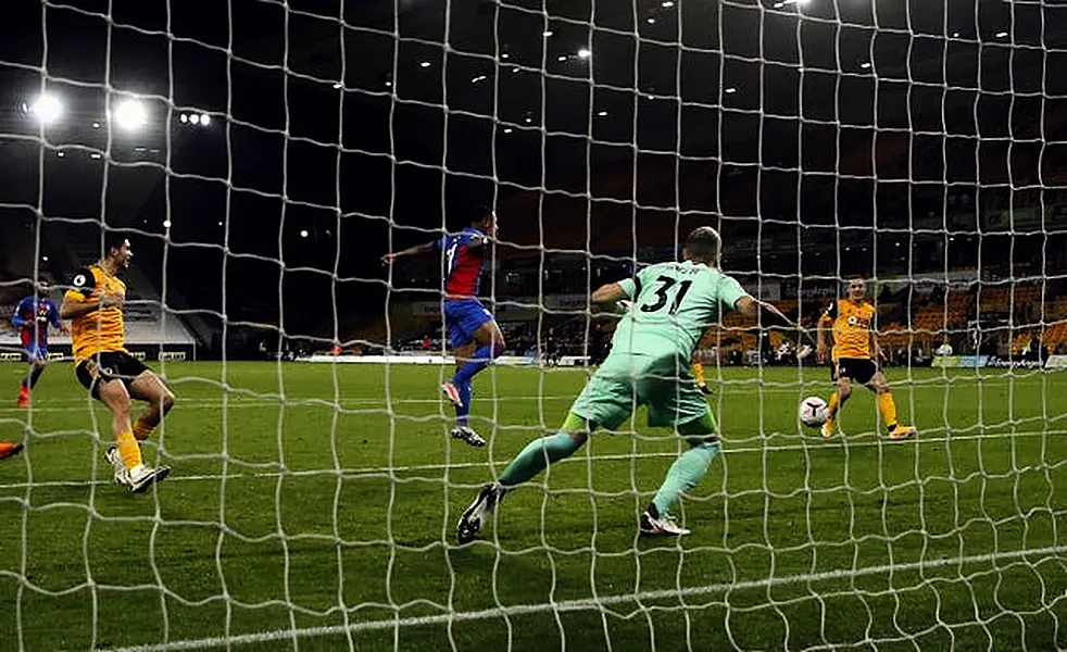 Daniel Podence, right, scores Wolves' second goal