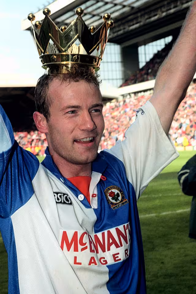 Alan Shearer wears the crown from the Premier League trophy after his 34 goals led Blackburn to the title