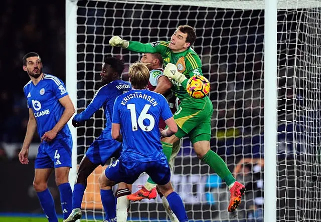 Leicester goalkeeper Mads Hermansen punches into his own goal while being challenged by Tomas Soucek, with the goal disallowed