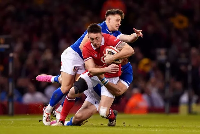 Josh Adams gets tackled by an Italy player