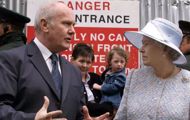 Northern Ireland secretary John Reid shows Queen Elizabeth II the site of the Omagh bombing during a visit to the County Tyrone town in 2002