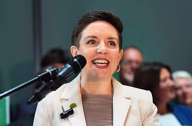 Green Party co-leader Carla Denyer speaks into a microphone