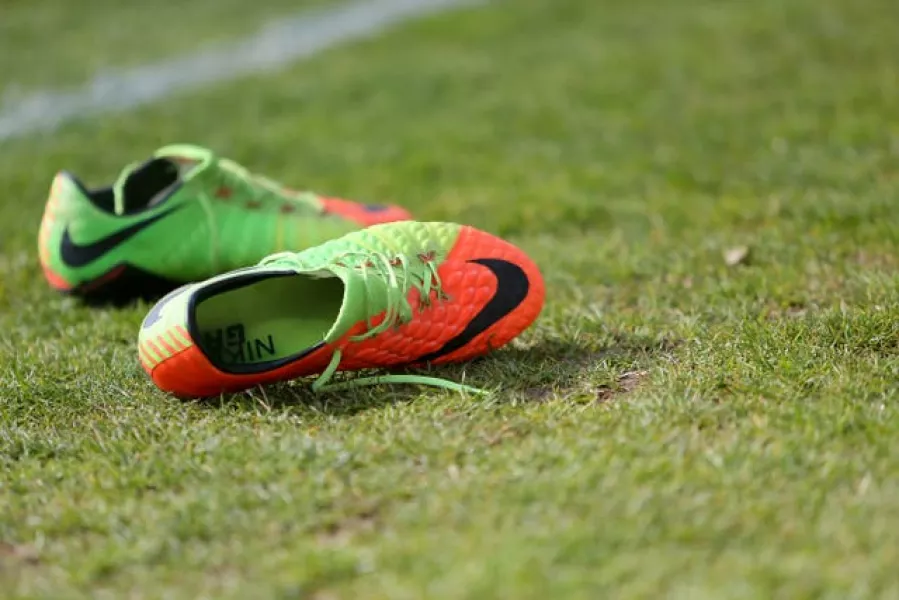 A pair of football boots on a pitch (Richard Sellers/AP)