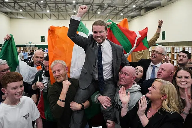 Donnchadh O Laoghaire being held up by supporters