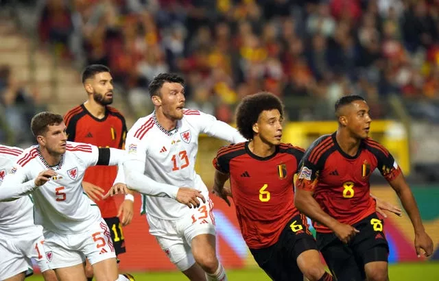 Wales’ Kieffer Moore and Belgium’s Axel Witsel wait for a free-kick to come in