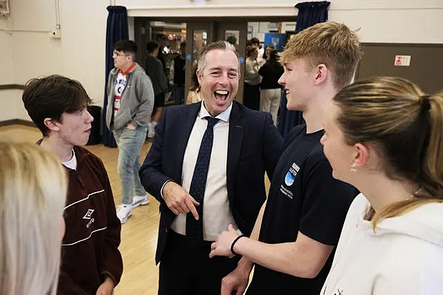 Education Secretary Paul Given joins students at Belfast High School as they receive their A-level results