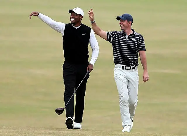 Tiger Woods (left) and Rory McIlroy waving at St Andrew's