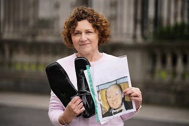 Marjorie Roddy holds the shoes of her uncle William McGreanery 