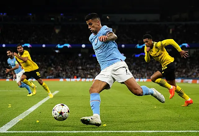 Manchester City’s Joao Cancelo (centre) in action during the UEFA Champions League Group G match at the Etihad Stadium, Manchester