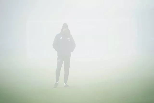 Graham Potter stands in the fog at Chelsea's Cobham Training Centre