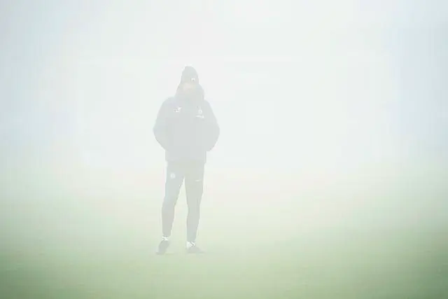 Graham Potter stands in the fog at Chelsea's Cobham Training Centre