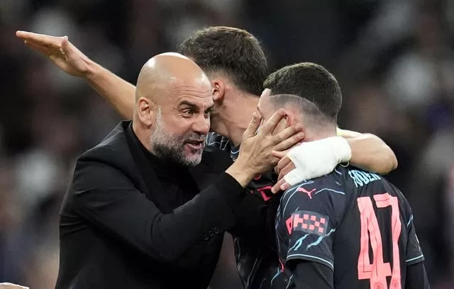 Pep Guardiola celebrates with Phil Foden